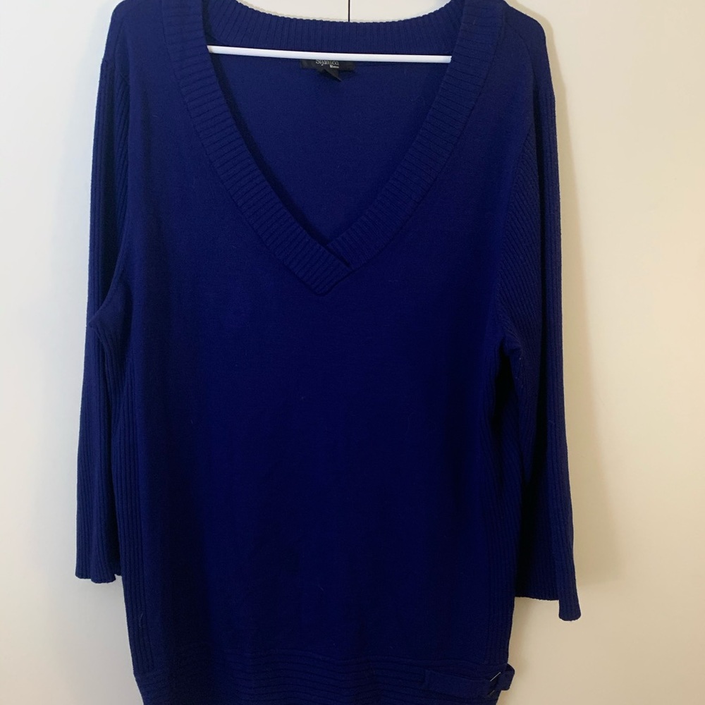 Navy blue sweater with buckle detail.